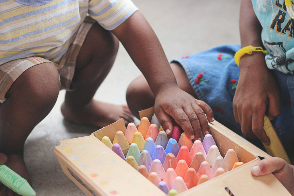 Photo of child with sidewalk chalk